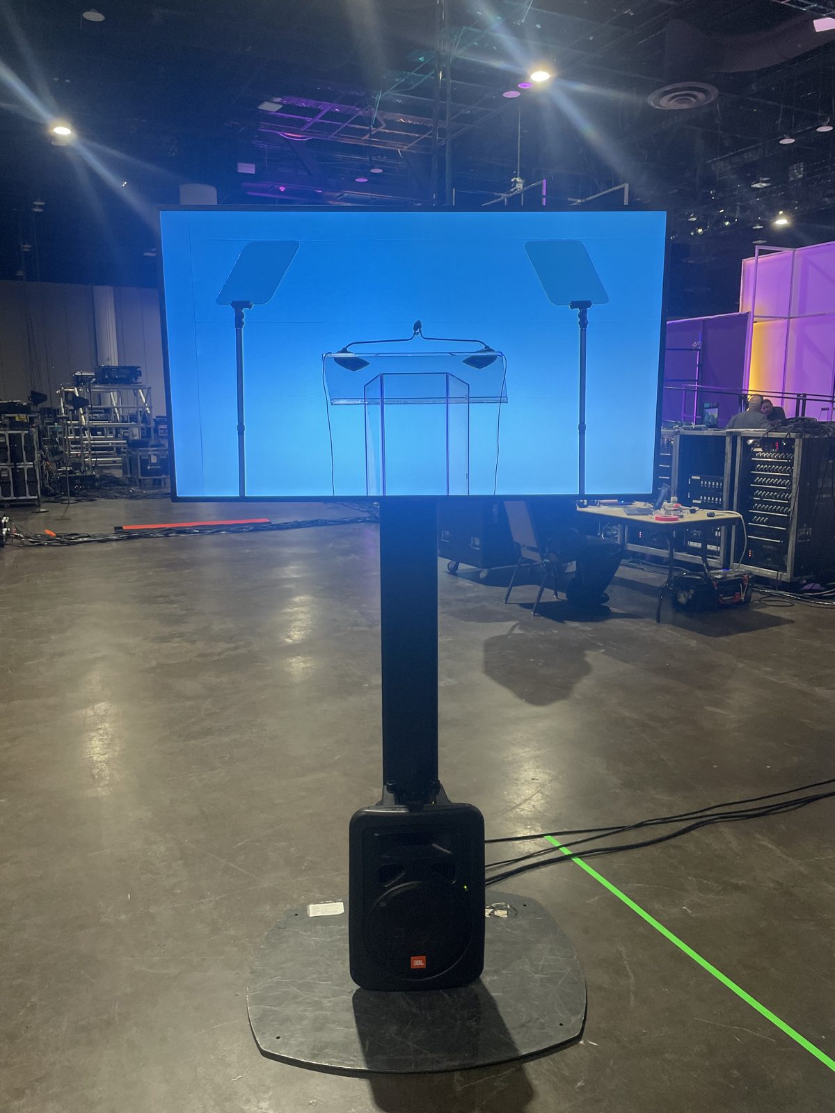 Tall teleprompter display on a stand in a convention hall